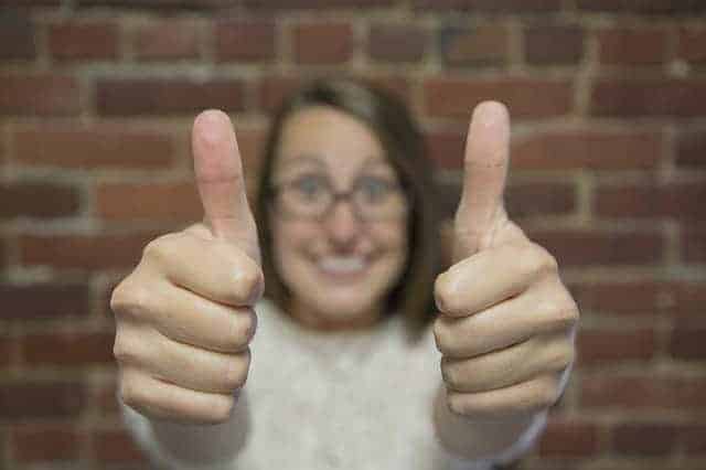 women with thumbs up